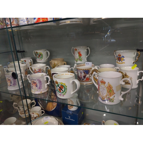 511 - Two shelves of Commemorative Loving Cups inc, Devon Ware, Royal Stafford, Aynsley and Royal Crown De... 