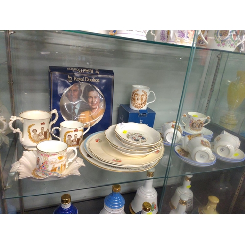 512 - Shelf of commemorative ware inc. part tea set ,plates and loving cups inc. Royal Winton ,Royal Doult... 