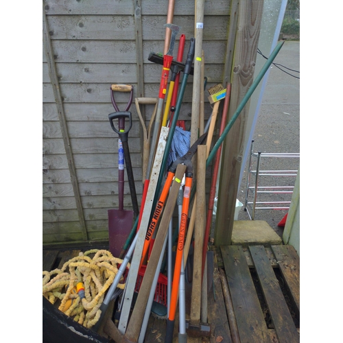 138 - Bundle of long handled gardening tools inc, garden hose , jump leads, clippers, rakes, spades, and s... 