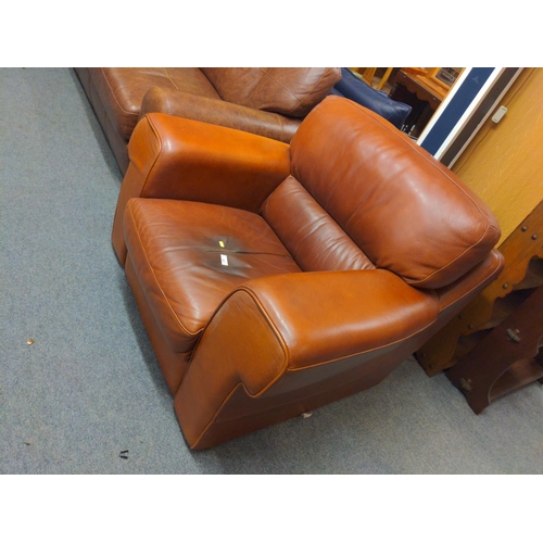 717 - Chestnut brown large leather armchair. 110cm wide x 100cm deep x 85cm high.