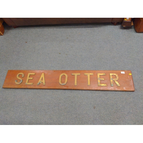 718 - Large sign, 'Sea Otter'. with brass letting mounted on mahogany. 153cm long x 25cm high.