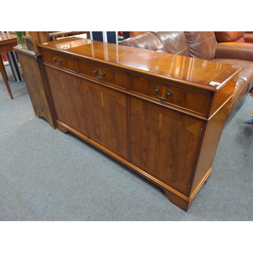 720 - Modern yew veneered sideboard, 3 drawers over 3 cupboards. With 2 keys. 146cm long x 37cm deep x 86c... 