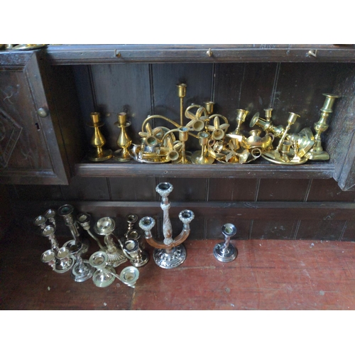 166 - Metal candlesticks over unit