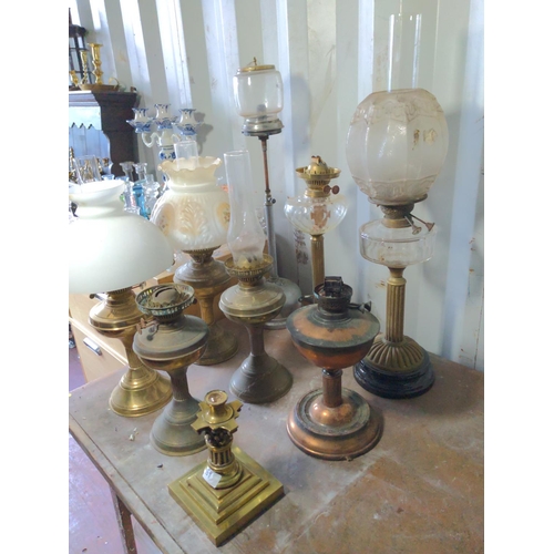 169 - 8 reeded oil lamps plus heavy brass base inc. Tilley, and four matching lamps.