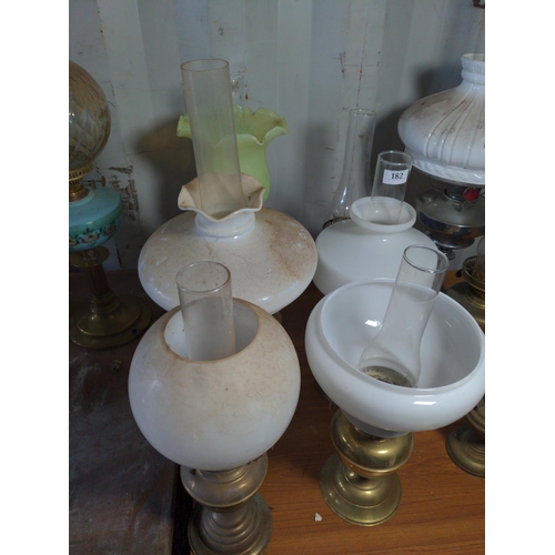 182 - Nine metal based oil lamps. Tallest 73 cm 