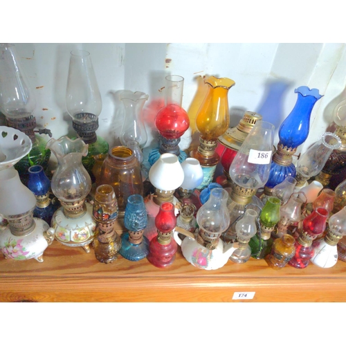 186 - Very large collection of minature oil lamps and burners.