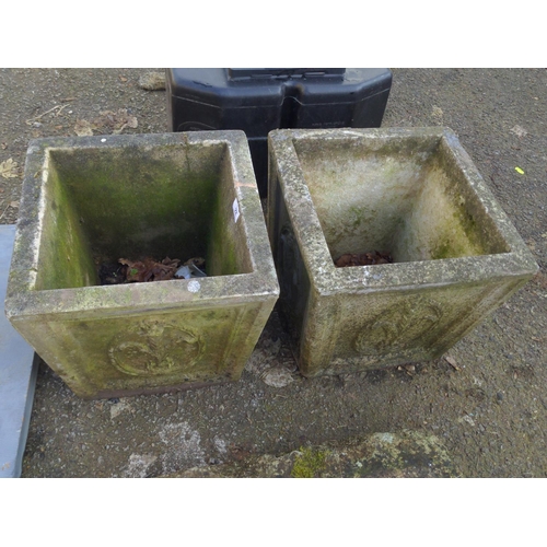 22 - Pair of concrete fleur de lis decorated square tapered garden planters. W36cm H32cm