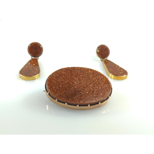 414 - Yellow metal & goldstone brooch and pair of pendant earrings, yellow metal tested positive for 9... 