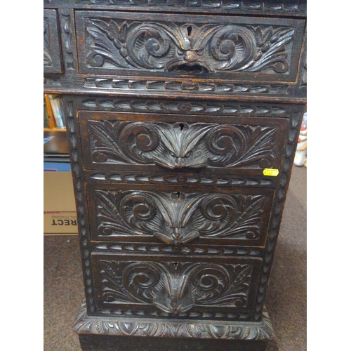 603 - Oak pedestal desk with leather inset on original wood & brass castors, drawers heavily carved wi... 