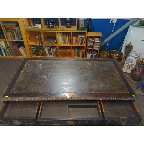 603 - Oak pedestal desk with leather inset on original wood & brass castors, drawers heavily carved wi... 