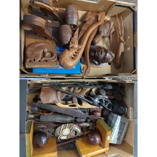 596 - Two boxes of carved wooden oriental and African artefacts 