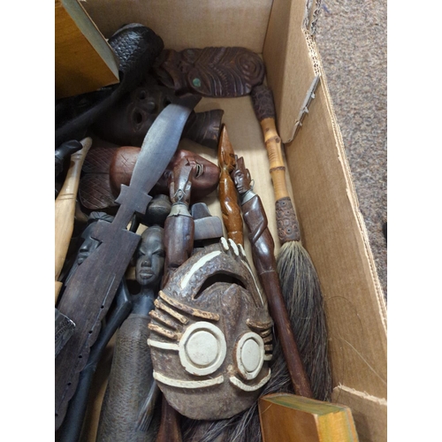 596 - Two boxes of carved wooden oriental and African artefacts 