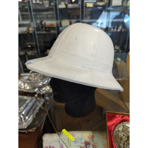 601 - Pith helmet by Hobson & sons. appears to have been painted