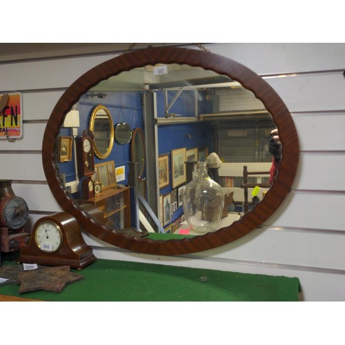 412 - Hardwood oval mirror with scalloped internal frame, on chain 77 x 57cm