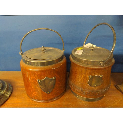 415A - Two oak biscuit barrels, both with ceramic liners and a central blank cartouche, height 15cm