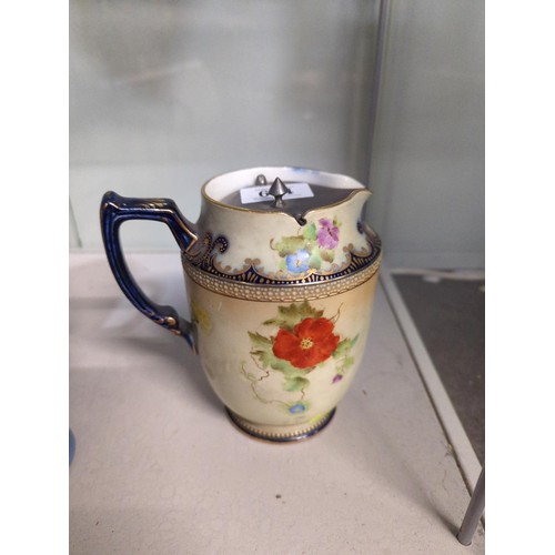 634 - Carlton Ware handled jug with pewter lid, decorated with floral design and gilded.