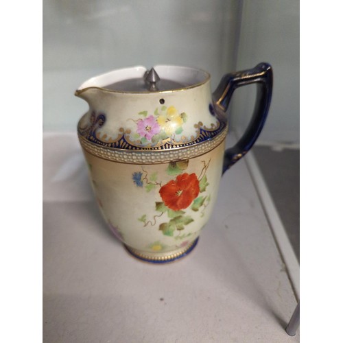 634 - Carlton Ware handled jug with pewter lid, decorated with floral design and gilded.