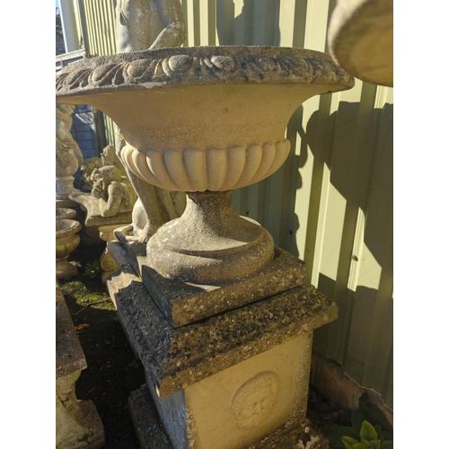 1 - An impressive pair of fluted urns, sat on square face adorned plinths. Plinths are of 3 parts, urns ... 