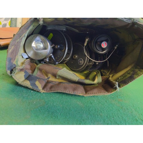 392 - Small camo bag with various fishing reels, flys & floats