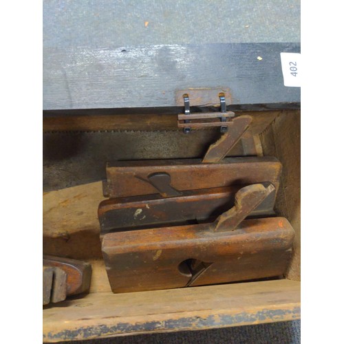 402 - Vintage wooden explosive box, Various vintage planes + saw, sharpening stone and vintage drill