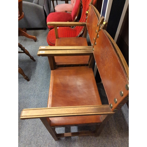 495 - Pair of leather seated & backed oak framed arm chairs. W55cm