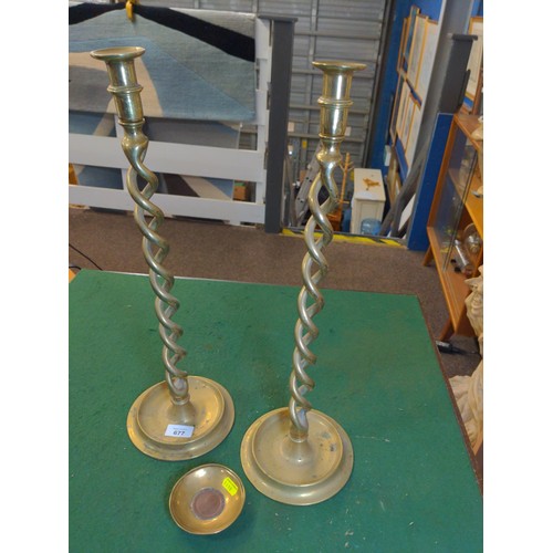 677 - Pair of twisted brass candlesticks, ht 51cms, with a small brass dish with cartwheel penny centre ma... 