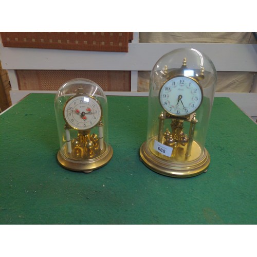 688 - 2 small glass domed brass clocks,tallest ht 23 cms inc dome