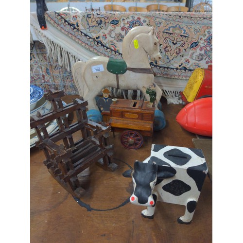 730 - Two novelty wooden money boxes, tramp art rocking chair & wheeled wooden horse