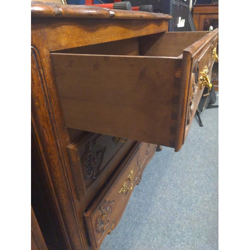 946 - An ornate 3 drawer chest with brass handles. 95cm long x 48cm deep x 80cm high