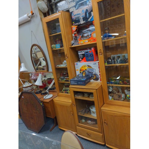 1055 - Ercol Windsor style elm display cabinet comprising two glazed display cupboards, two lower cupboards... 