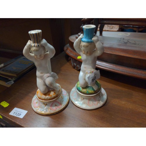 943 - Two continental porcelain figures of chubby putti, each 18cm height, possible candlesticks or centre... 