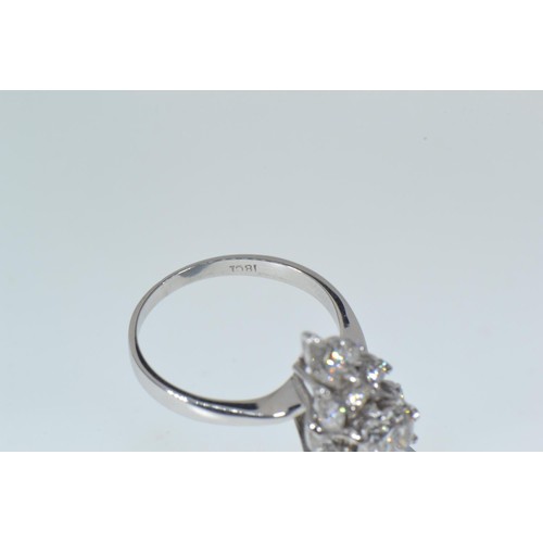 564 - 18ct white gold & diamond cluster ring, of off set lozenge design, the centre set with a brillia... 