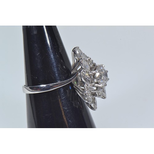 564 - 18ct white gold & diamond cluster ring, of off set lozenge design, the centre set with a brillia... 