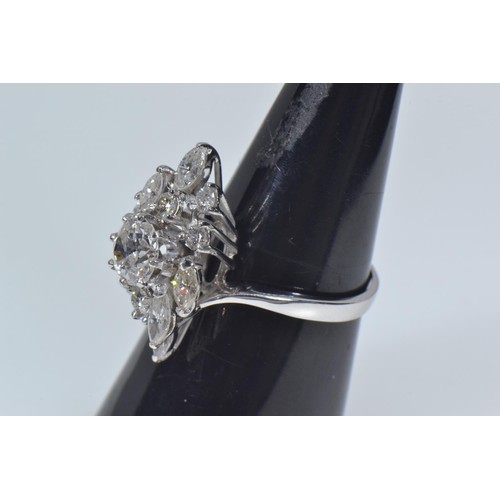 564 - 18ct white gold & diamond cluster ring, of off set lozenge design, the centre set with a brillia... 