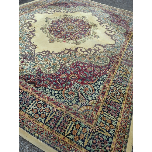 739 - Large English floral patterned rug, with central medallion. W320cm L407cm