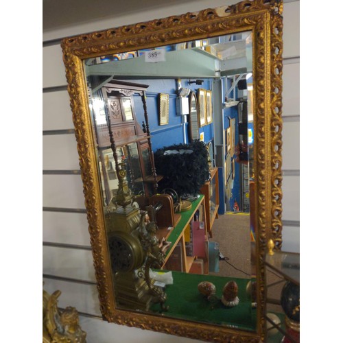 385 - Rectangular bevelled gilt framed mirror, some losses to frame, 44 x 70cm