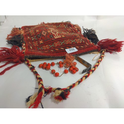 604 - Red ground rug bag, body length 30cm excluding tassels