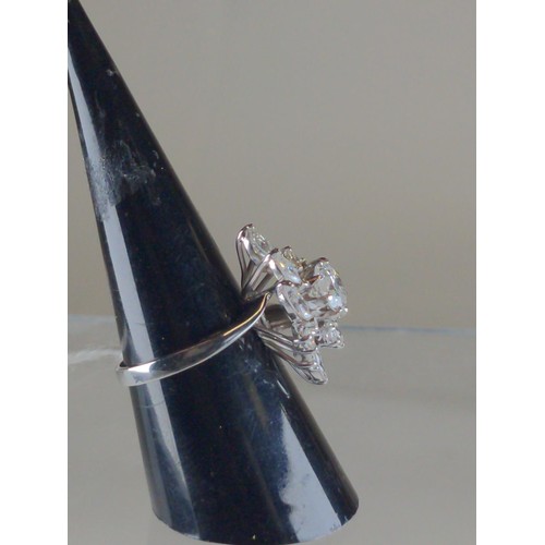 564 - 18ct white gold & diamond cluster ring, of off set lozenge design, the centre set with a brillia... 