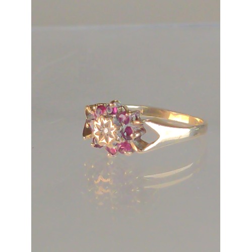 568 - 9ct gold, diamond & red stone cluster ring, size K, London hallmark, gross weight 2.2 grams