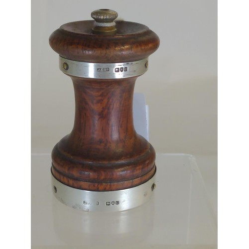 592 - Silver banded wooden pepper grinder, hallmarked John Grinsell & Sons, London 1898, height 9cm