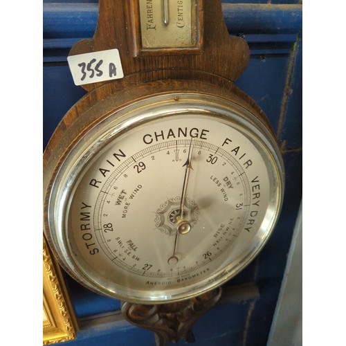 355A - Large banjo British made aneroid barometer in an oak casement.