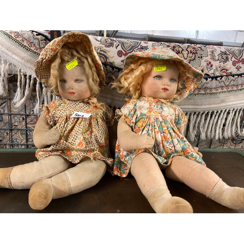 500A - Pair of vintage fabric and canvas stuffed twin dolls. 