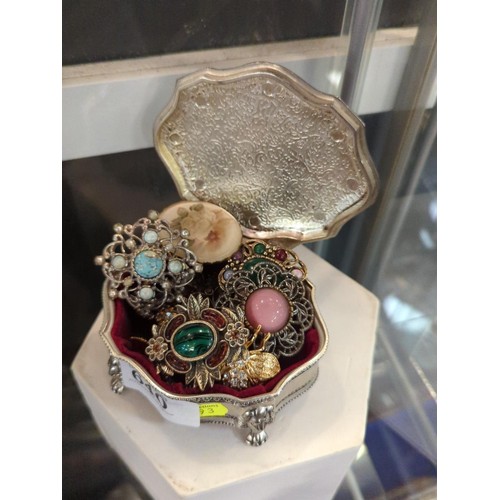 640 - Plated box with costume jewellery, mostly brooches