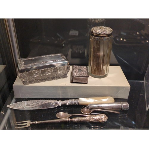 647 - Collection of eight pieces of silverware, including two silver lidded vanity pots, flatware, matchbo... 