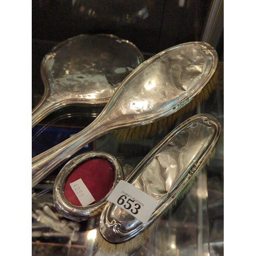 653 - Silver three piece vanity set, William Devenport, Birmingham 1917 and a small oval silver photo fram... 