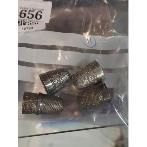 656 - Four silver thimbles, various makers & dates, gross weight 21 grams, together with a plated thim... 