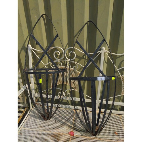 13 - Pair of oval metal wall baskets. H76cm