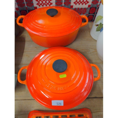 521 - Two lidded cast enamel Le Creuset cooking pots together with a Le Creuset trivet. Sauté pan w. 33 x ... 