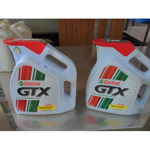 57 - 2 Castrol GTX 10W-40 oil bottles. One full, one part filled.