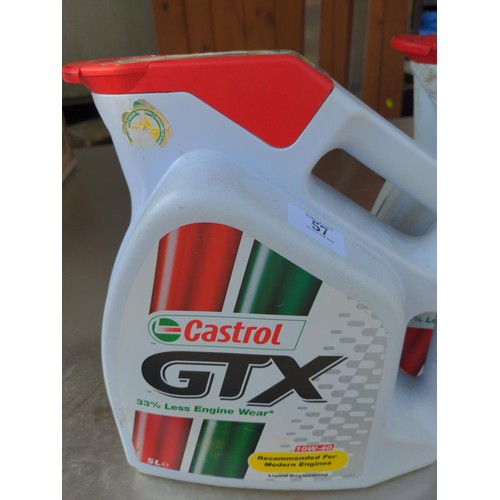 57 - 2 Castrol GTX 10W-40 oil bottles. One full, one part filled.